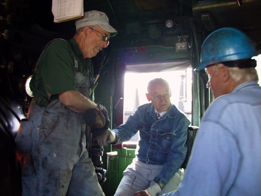 Ernie (L) and Harry (R) talk with the conductor, Stettler, Alberta, 11 August 2001