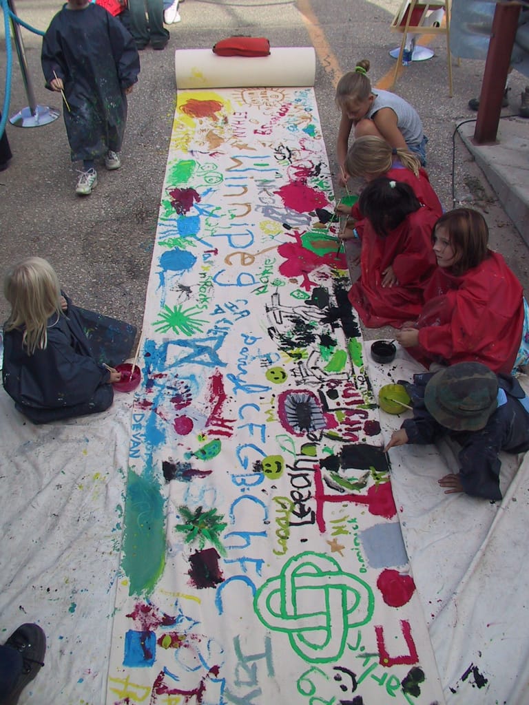 Kids paint on the mural, Winnipeg, Manitoba, 16 September 2002